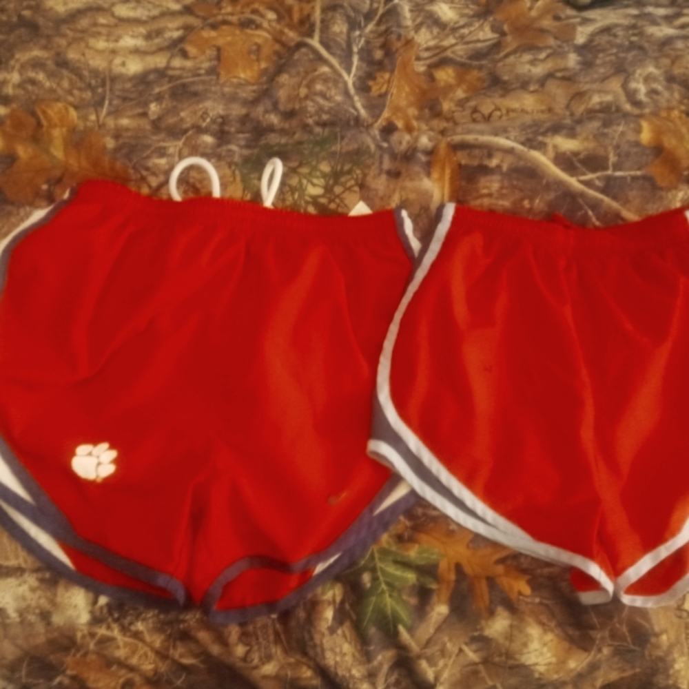 2 pair Nike DRI fit shorts 1 red and black one is orange and blue. Both xs